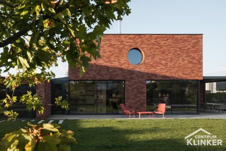 Dům v kulatým oknem a moderní cihlovou fasádou